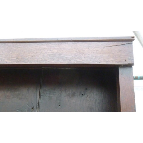 665 - An 18th century oak breakfront dresser, plate rack with three shelves and turned pilaster decoration... 