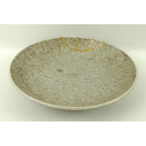 68 - A Chinese ceramic circular dish, 18th century, Yong Zheng period, with Ge type glaze, dark celadon c... 