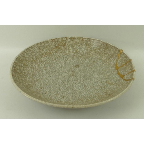 68 - A Chinese ceramic circular dish, 18th century, Yong Zheng period, with Ge type glaze, dark celadon c... 