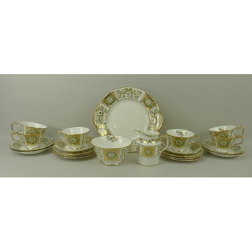 74 - A Royal Crown Derby part tea service, in the Green Derby Panel pattern, comprising a cake plate, mil... 