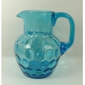 A White Friars blue glass jug, with dimple effect to bowl and ground base, 18cm high.