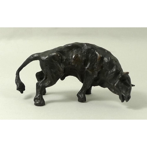 693 - A bronze figure of a raging bull, 20th century, monogrammed J.M, 5 by 9cm.