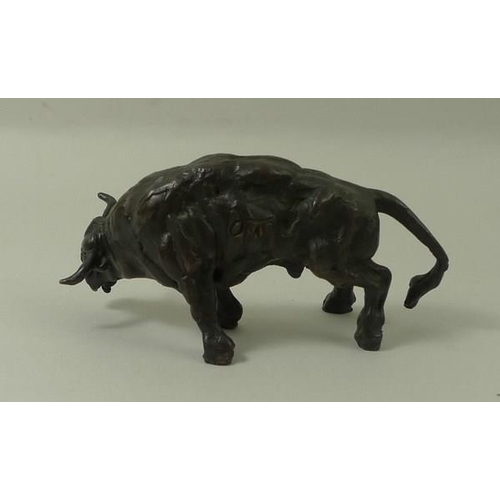 693 - A bronze figure of a raging bull, 20th century, monogrammed J.M, 5 by 9cm.