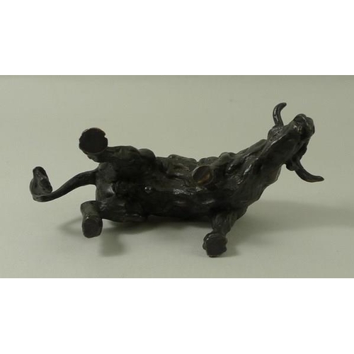 693 - A bronze figure of a raging bull, 20th century, monogrammed J.M, 5 by 9cm.