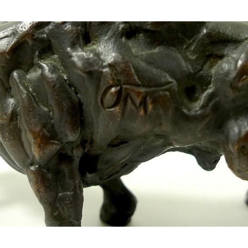 693 - A bronze figure of a raging bull, 20th century, monogrammed J.M, 5 by 9cm.