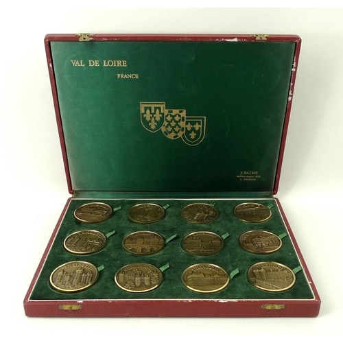 693A - A set of twelve French bronze medallions of Chateaux in the Val de Loire, in a presentation box.