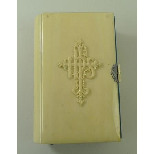 697 - An ivory bound book, 'The Book of Common Prayer', 19th century, with raised motif to front cover, si... 