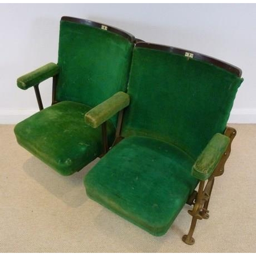 698 - A pair of folding cinema theatre seats, early 20th century, with cast iron stands and green velour u... 