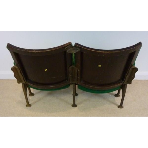 698 - A pair of folding cinema theatre seats, early 20th century, with cast iron stands and green velour u... 