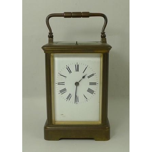 700 - A brass cased repeating carriage clock, the white enamel dial with Roman numerals, bevelled glass, a... 