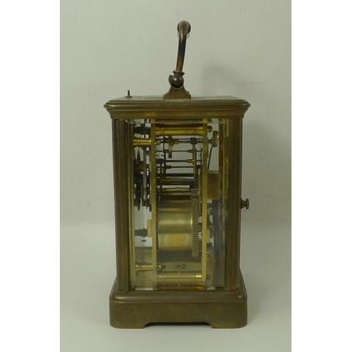 700 - A brass cased repeating carriage clock, the white enamel dial with Roman numerals, bevelled glass, a... 