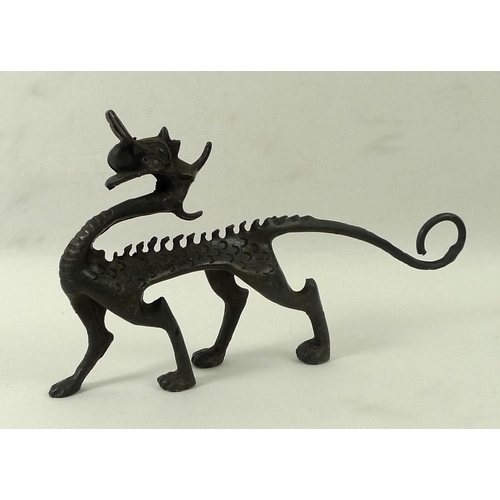 701 - An Art and Crafts bronze figure of a dragon, 15 by 9cm high.