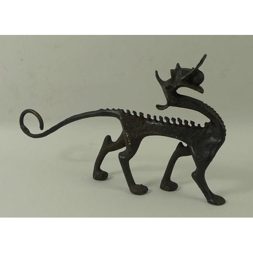 701 - An Art and Crafts bronze figure of a dragon, 15 by 9cm high.