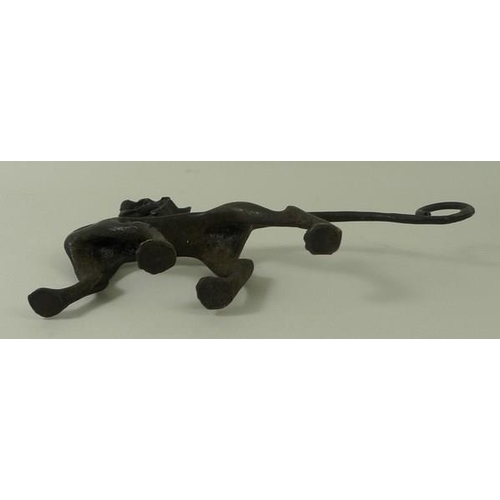 701 - An Art and Crafts bronze figure of a dragon, 15 by 9cm high.