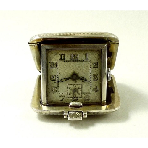 702 - A silver cased travelling watch, Birmingham 1931, SSM, engine turned, with luminous Arabic numerals ... 