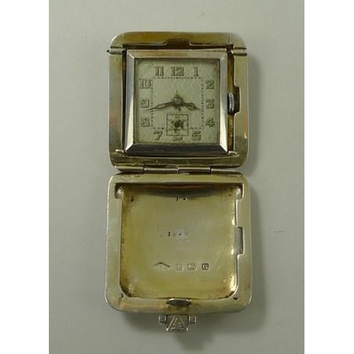 702 - A silver cased travelling watch, Birmingham 1931, SSM, engine turned, with luminous Arabic numerals ... 