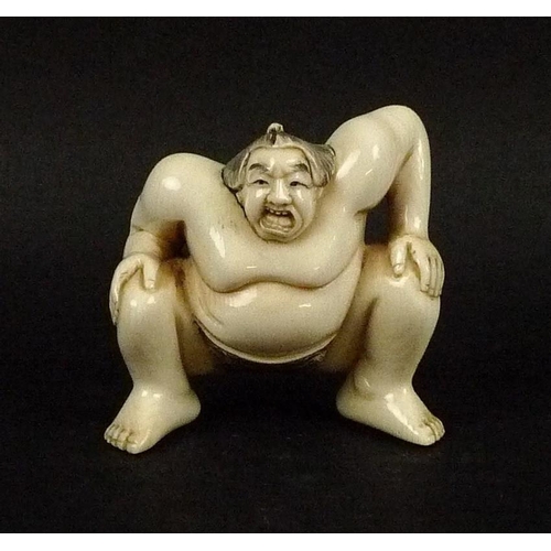 704 - A late 19th/early 20th century Japanese ivory netsuke, modelled as a sumo wrestler, signed to base, ... 