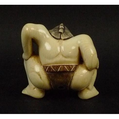 704 - A late 19th/early 20th century Japanese ivory netsuke, modelled as a sumo wrestler, signed to base, ... 