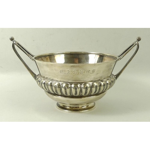 720 - An Art and Crafts silver bowl, with repeating gadrooned ellipses and two stylised elongated handles,... 