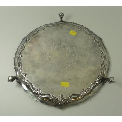 727 - A silver salver, with cast bead and leaf rim, the reserve with a griffin, on ball and claw feet, She... 