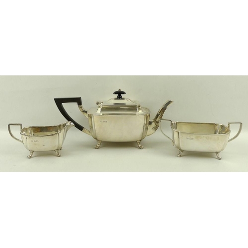 732 - An Art Deco silver three piece tea service of oblong form with incuse corners, comprising tea pot wi... 