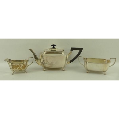 732 - An Art Deco silver three piece tea service of oblong form with incuse corners, comprising tea pot wi... 