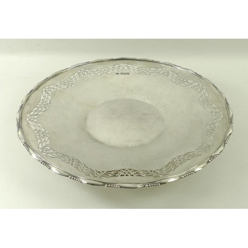 736 - A silver circular cake plate, fret cut band and applied cast rim, raised on a circular foot, Sheffie... 