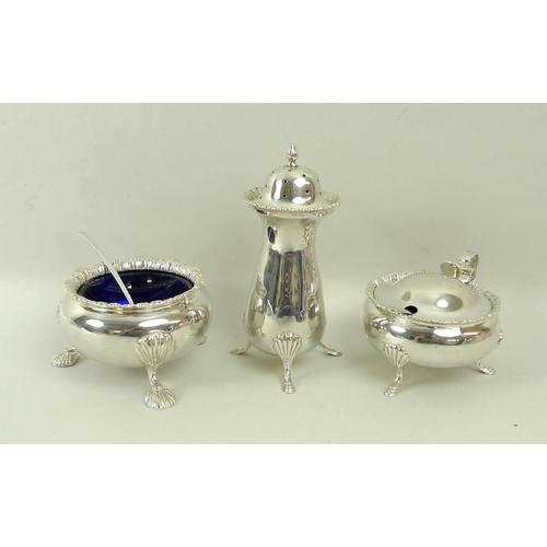 739 - A silver three piece cruet set, comprising mustard pot with blue glass liner, and pepper shaker, Bir... 