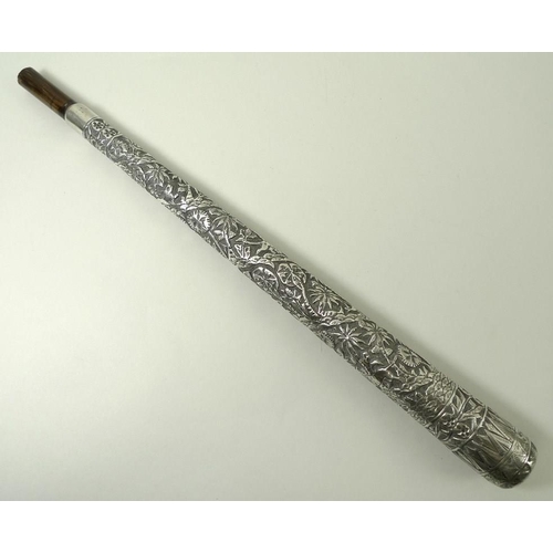 741 - An Indian silver metal parasol handle, deeply engraved with forest animals, 34cm.