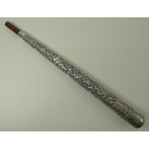 741 - An Indian silver metal parasol handle, deeply engraved with forest animals, 34cm.