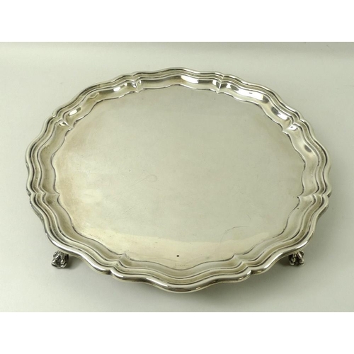 744 - A silver salver, Chippendale piecrust edge, raised on four ball and claw feet, Sheffield 1924, James... 