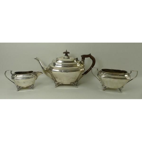 747 - An Edwardian three piece silver tea set, of oblong form with canted corner, comprising teapot with B... 