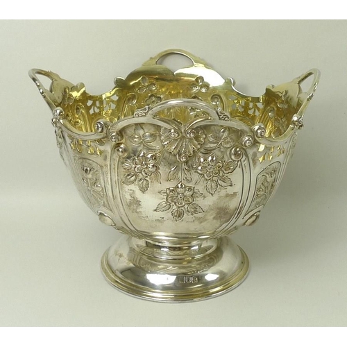 749 - A Victorian silver rose bowl, the embossed bowl with cast scrolled rim, gilt interior, raised on a d... 