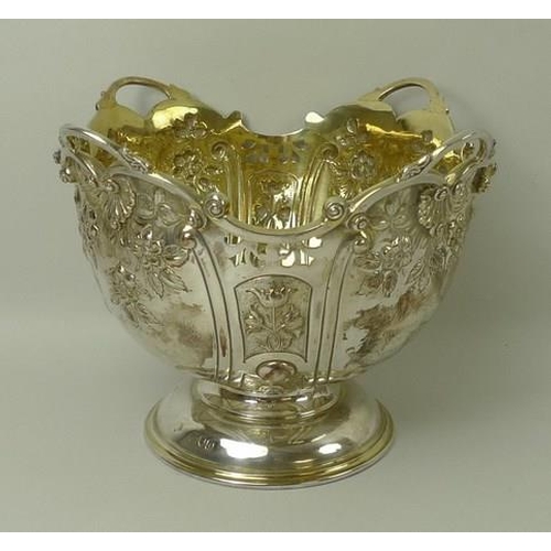 749 - A Victorian silver rose bowl, the embossed bowl with cast scrolled rim, gilt interior, raised on a d... 