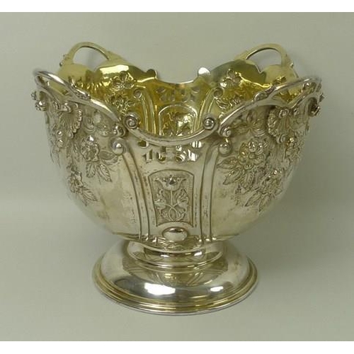 749 - A Victorian silver rose bowl, the embossed bowl with cast scrolled rim, gilt interior, raised on a d... 