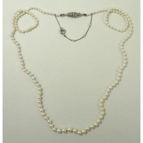 777 - An Edwardian Art Deco cultured pearl necklace, strung with graduating pearls, 1mm to 4mm, on a diamo... 