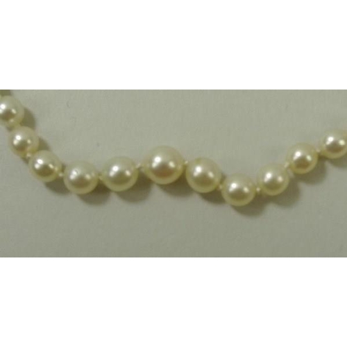 777 - An Edwardian Art Deco cultured pearl necklace, strung with graduating pearls, 1mm to 4mm, on a diamo... 