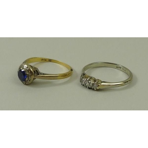 783 - An 18ct gold, sapphire and diamond ring, the central circular sapphire surrounded eight chip diamond... 