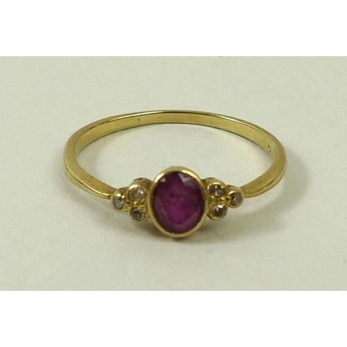 786 - A 9ct gold ring set with a central ruby/pink amethyst, flanked either side by three diamonds, size L... 