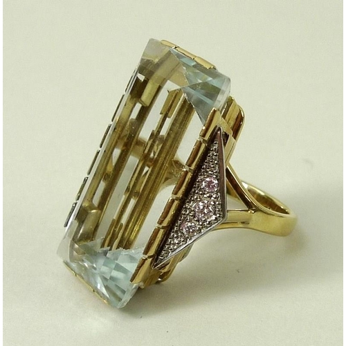 790 - An 18ct gold Art Deco French designer dress ring, the central pale blue untreated topaz 15 by 30mm, ... 