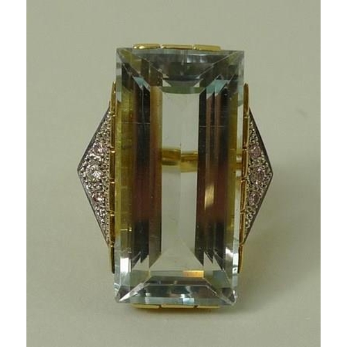 790 - An 18ct gold Art Deco French designer dress ring, the central pale blue untreated topaz 15 by 30mm, ... 