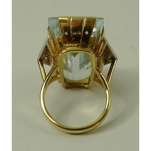 790 - An 18ct gold Art Deco French designer dress ring, the central pale blue untreated topaz 15 by 30mm, ... 