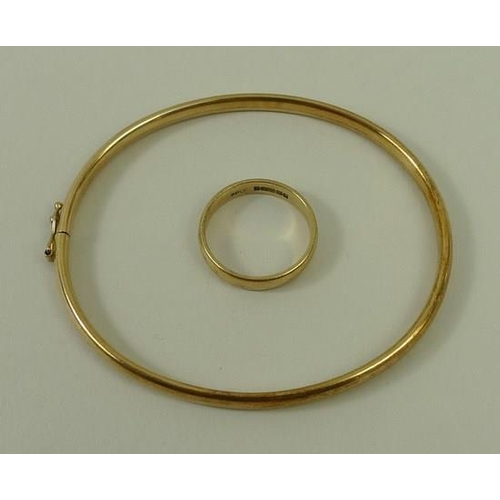 793 - A 9ct gold hoop bangle, together with a 9ct gold wedding band, size M, 7.6g total weight. (2)