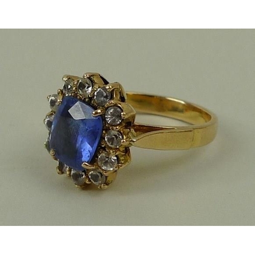 796 - A 9ct gold and sapphire ring in a surround of white sapphires, approximately 3ct, size N, 5.7g total... 