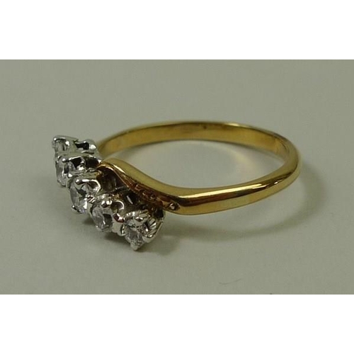 799 - An 18ct gold and diamond crossover ring, set with five graduated diamonds, total approximately 0.55c... 