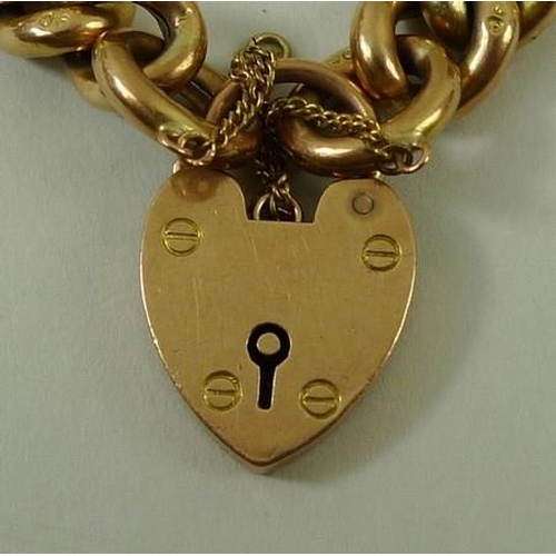 802 - A 9ct gold link bracelet with pad lock clasp and safety chain, 20.2g.