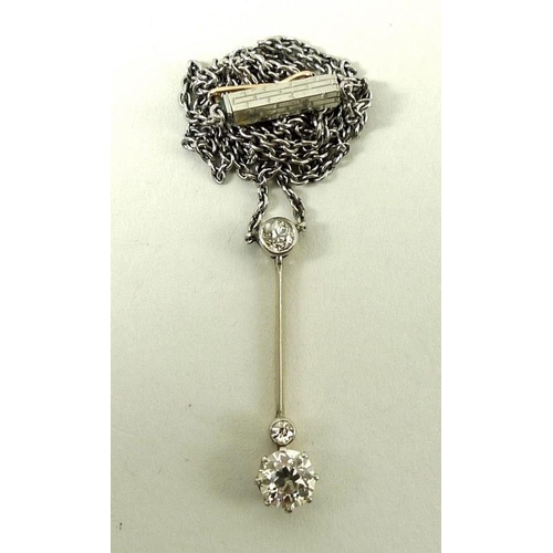 803 - An unmarked gold pendant necklace, set with a 0.5ct diamond on a slender bar, and two further smalle... 