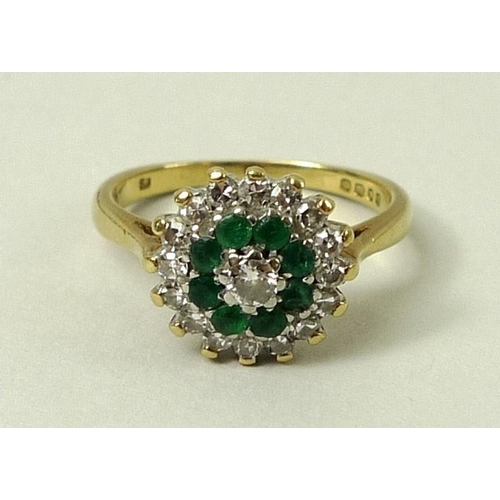 804 - An 18ct gold, diamond and emerald cluster ring, the central diamond of approximately 0.2ct encircled... 