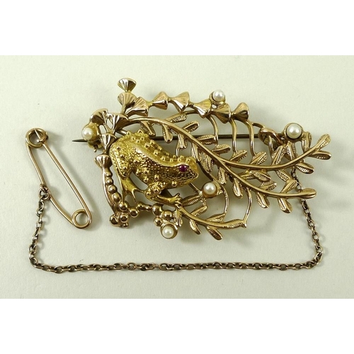 805 - A 9ct gold, seed pearl and ruby brooch formed as a frog amongst ferns, 15.2g total weight.