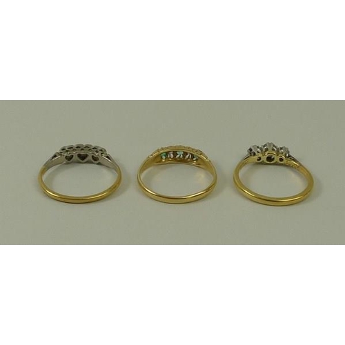 806 - An 18ct gold, diamond and emerald five stone ring, size N, an 18ct gold and diamond three stone ring... 